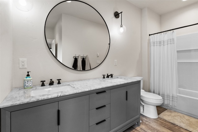 full bathroom with hardwood / wood-style floors, vanity, toilet, and shower / bathtub combination with curtain