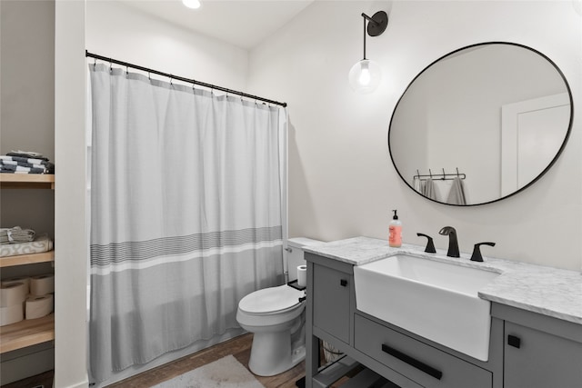 full bathroom featuring shower / tub combo, vanity, toilet, and hardwood / wood-style floors