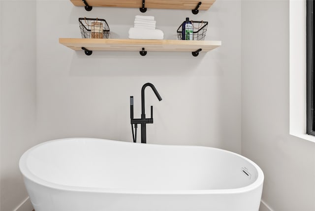 interior space featuring sink and a tub