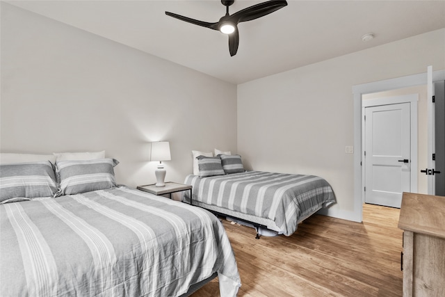 bedroom with ceiling fan and light hardwood / wood-style floors