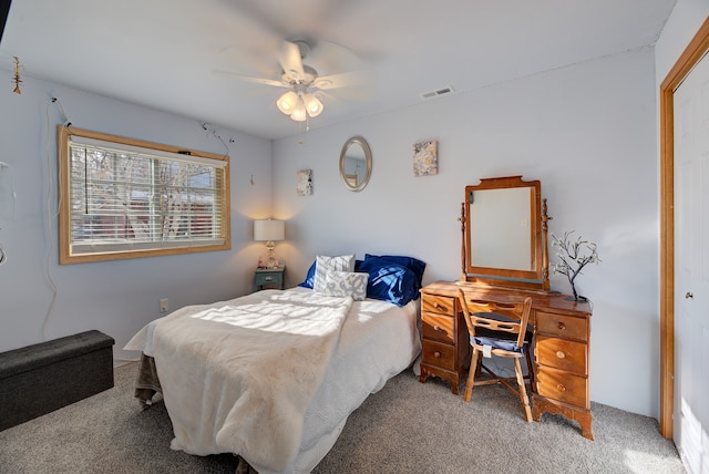 carpeted bedroom featuring ceiling fan and a closet