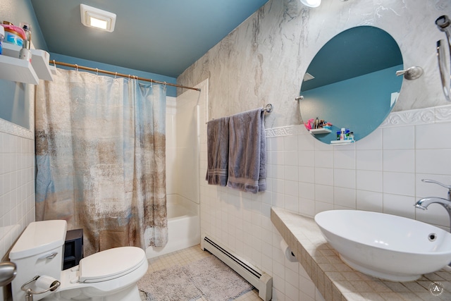 full bathroom with sink, baseboard heating, tile patterned flooring, toilet, and tile walls