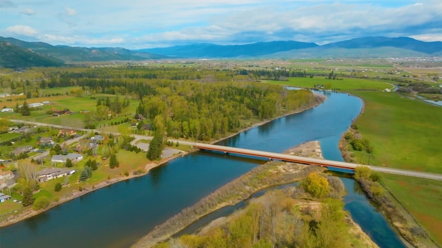 drone / aerial view featuring a water and mountain view