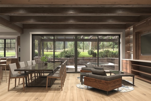 dining area featuring beamed ceiling, built in features, and light hardwood / wood-style flooring