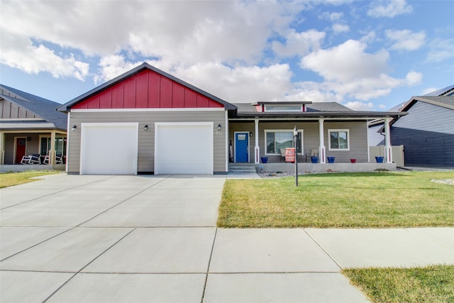 view of front of property with a front lawn, a porch, and a garage