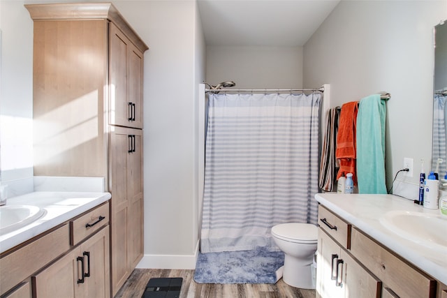 bathroom with a shower with shower curtain, vanity, toilet, and wood-type flooring