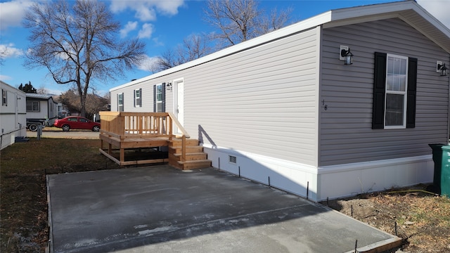 view of property exterior with a patio area