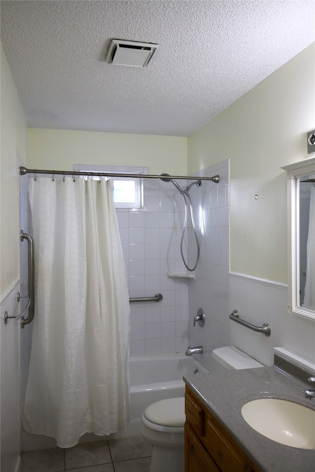 full bathroom featuring tile patterned flooring, vanity, a textured ceiling, and toilet