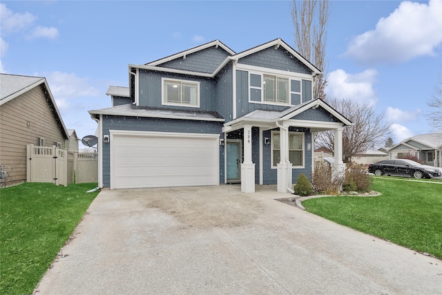 craftsman inspired home with a garage and a front lawn