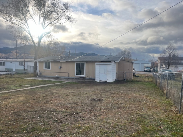 rear view of property featuring a yard