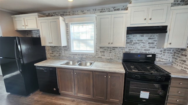 kitchen with dark wood-type flooring, black appliances, white cabinets, crown molding, and sink