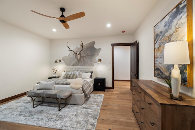 bedroom with light hardwood / wood-style flooring and ceiling fan