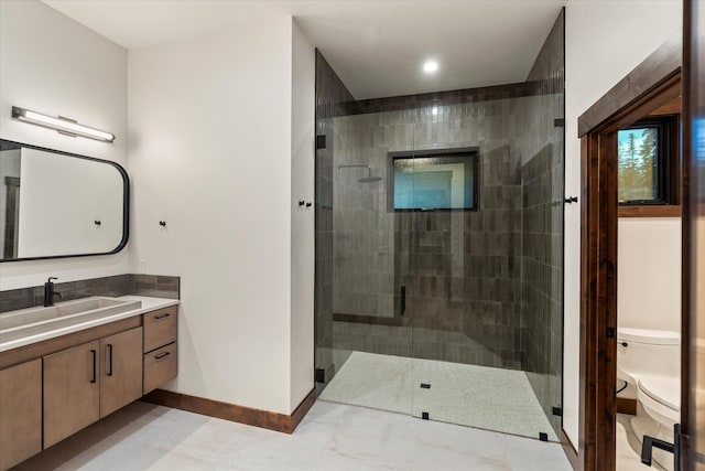 bathroom with vanity, an enclosed shower, and toilet