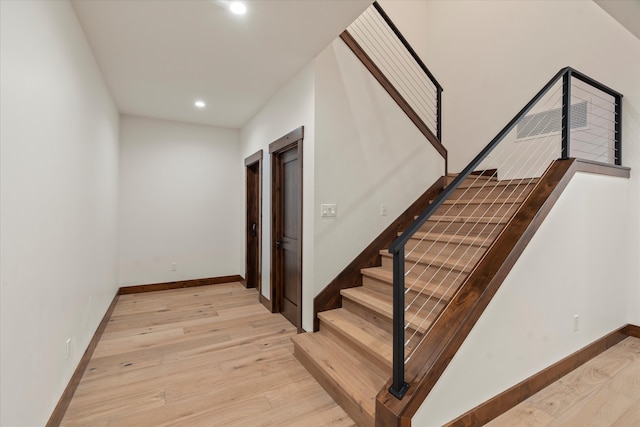 staircase featuring wood-type flooring