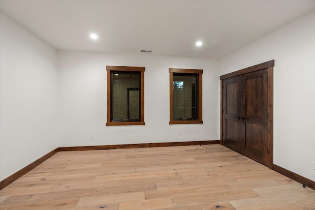 spare room with light hardwood / wood-style floors