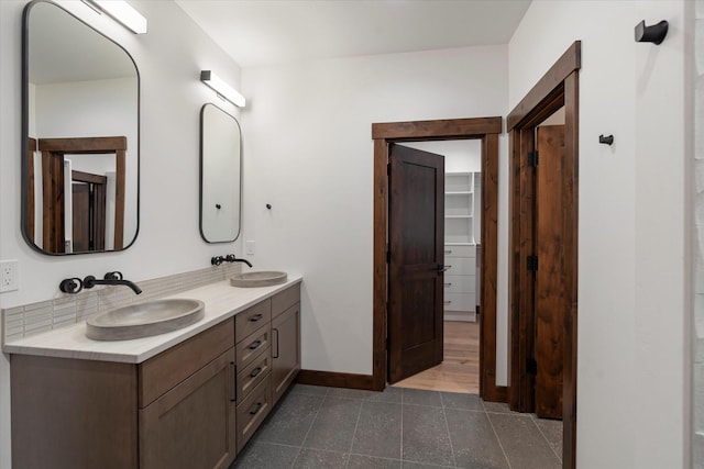 92 Woodlandstar Cir, Whitefish, MT 59937 - bathroom with double vanity, tile patterned flooring, baseboards, and a sink