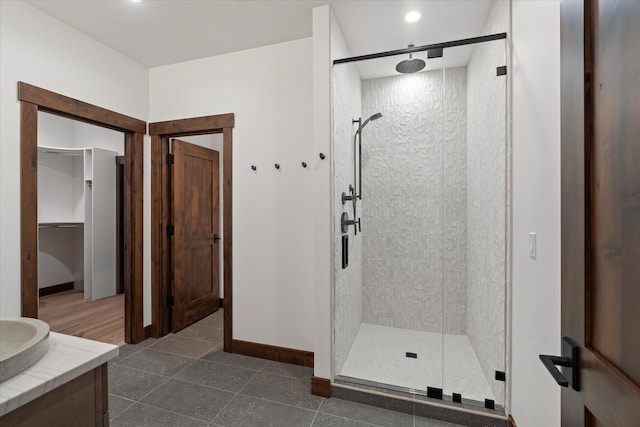 bathroom featuring vanity and a shower with shower door