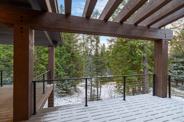 snow covered deck featuring a pergola