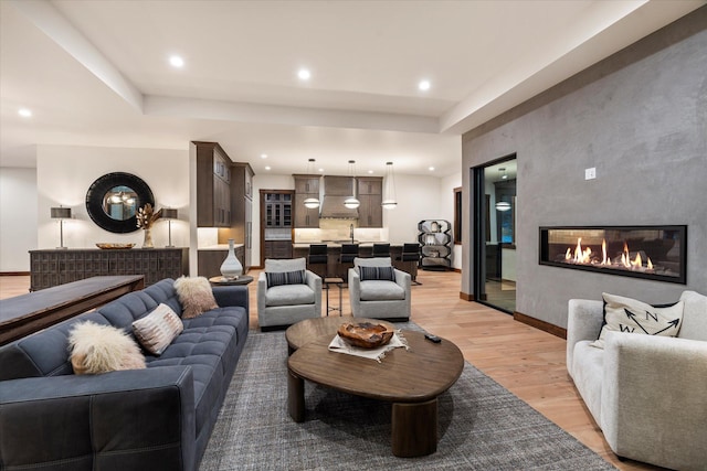 92 Woodlandstar Cir, Whitefish, MT 59937 - living room with light wood-type flooring, a fireplace, baseboards, and recessed lighting