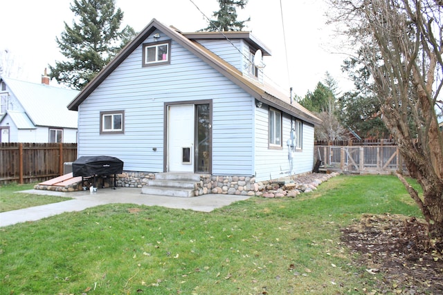 rear view of property with a lawn