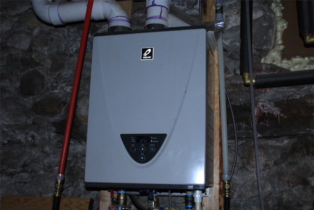 utility room with tankless water heater