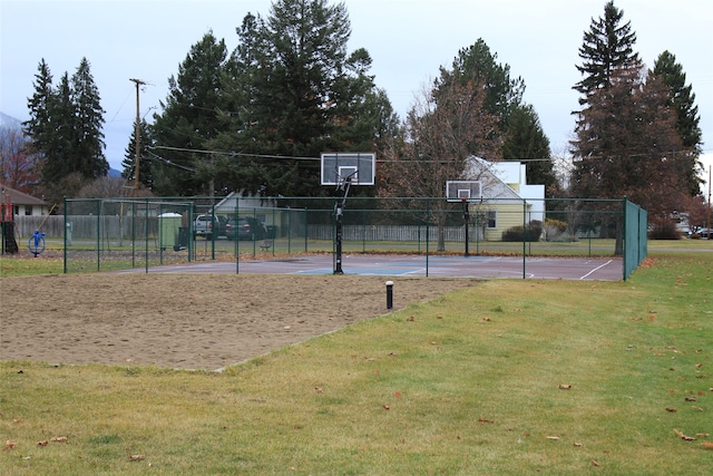 view of sport court with a lawn