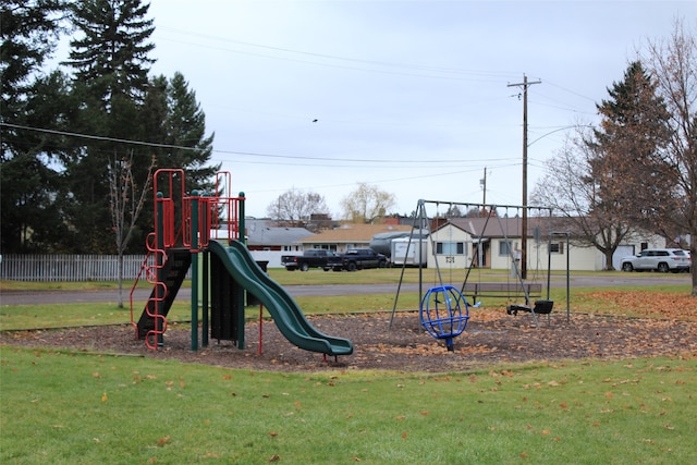 view of jungle gym featuring a lawn