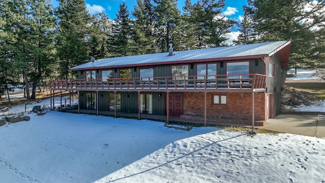 snow covered property featuring a wooden deck