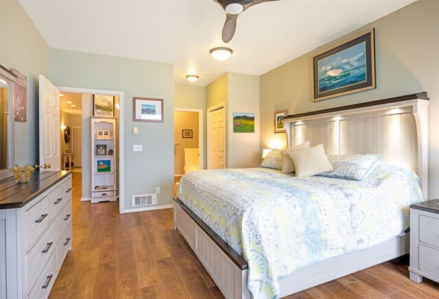 bedroom with wood-type flooring, ensuite bath, and ceiling fan