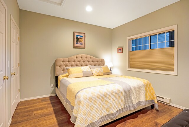 bedroom featuring dark hardwood / wood-style flooring and baseboard heating