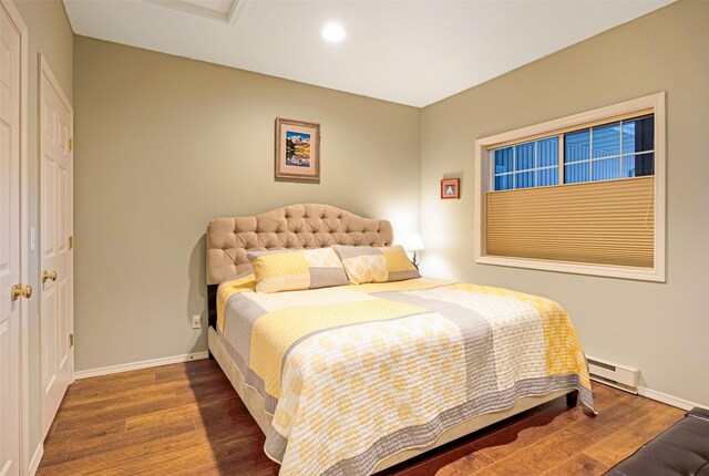 100 Rocky Point Rd Unit F5, Polson, MT 59860 - bedroom with baseboard heating, wood finished floors, baseboards, and recessed lighting
