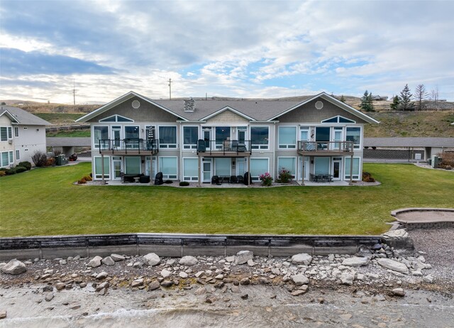 back of property featuring a deck and a yard