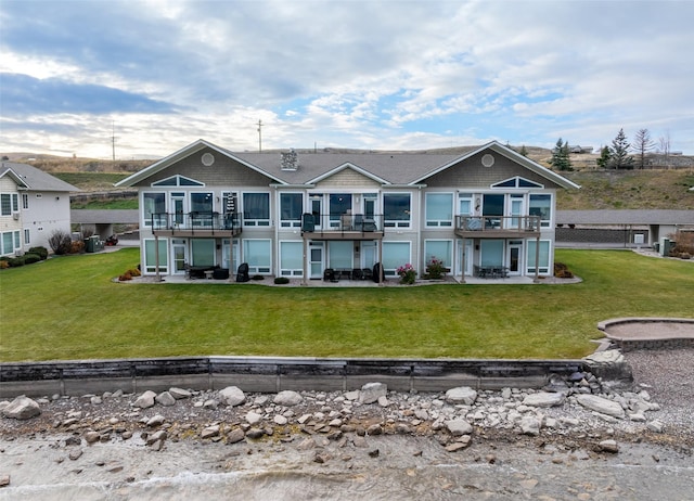 100 Rocky Point Rd Unit F5, Polson, MT 59860 - back of property featuring a patio area, a yard, and a balcony