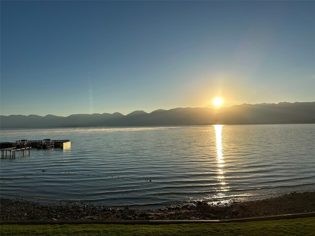 water view with a mountain view and a boat dock