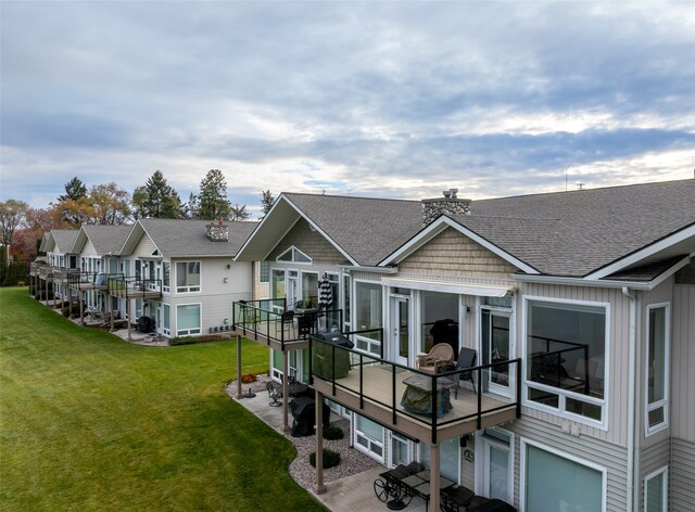 rear view of property with a lawn