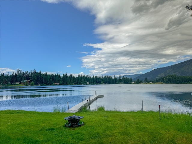 water view with a mountain view, a dock, and a fire pit