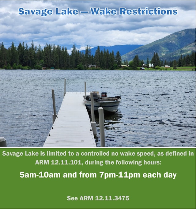 view of dock featuring a water and mountain view