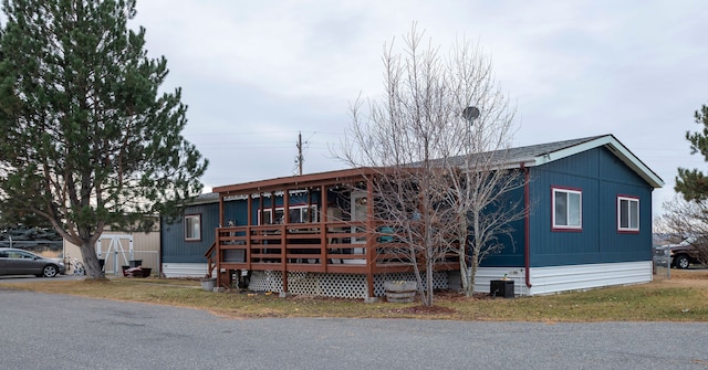 view of front facade featuring a shed and a wooden deck