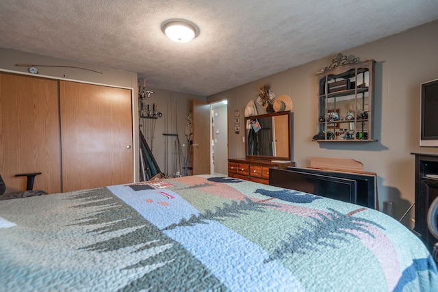 bedroom with a textured ceiling and a closet