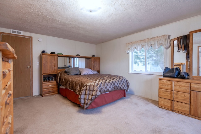 carpeted bedroom featuring a textured ceiling