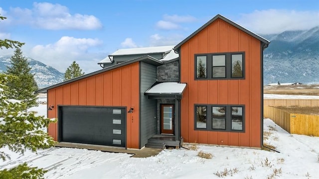 contemporary house featuring a mountain view and a garage