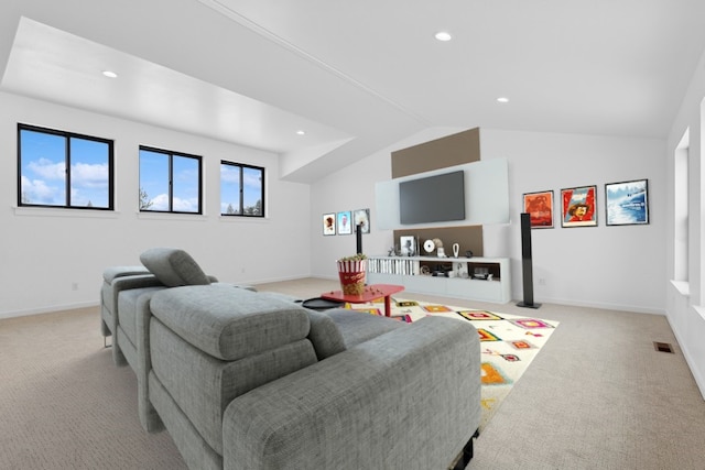 living room featuring light colored carpet and vaulted ceiling