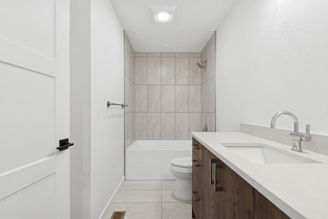 full bathroom featuring tile patterned flooring, vanity, toilet, and tiled shower / bath combo