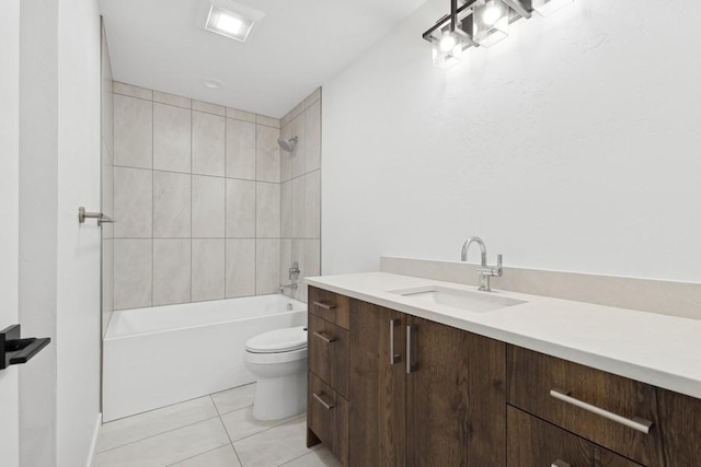 full bathroom with tile patterned flooring, vanity, tiled shower / bath combo, and toilet