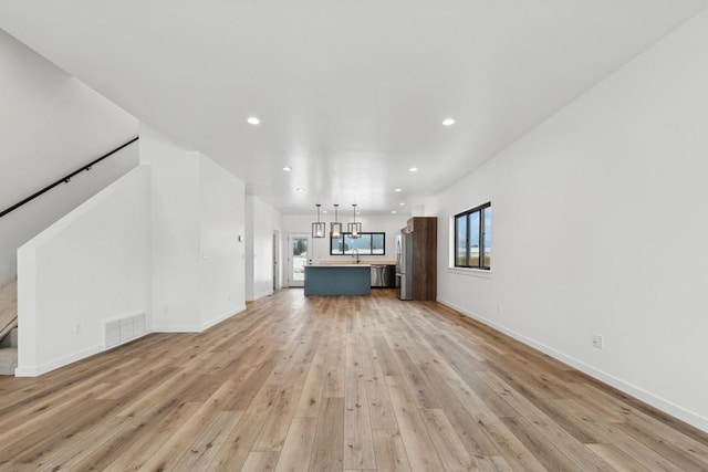 unfurnished living room with light hardwood / wood-style floors