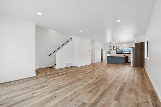 unfurnished living room featuring light hardwood / wood-style flooring