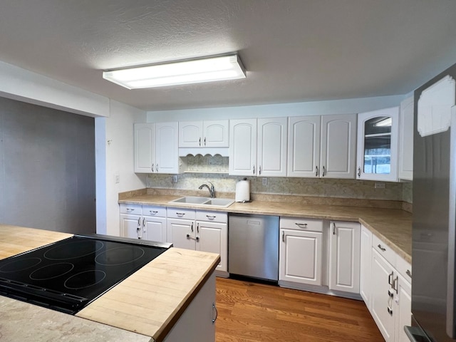 kitchen with dark hardwood / wood-style flooring, white cabinetry, sink, and stainless steel appliances