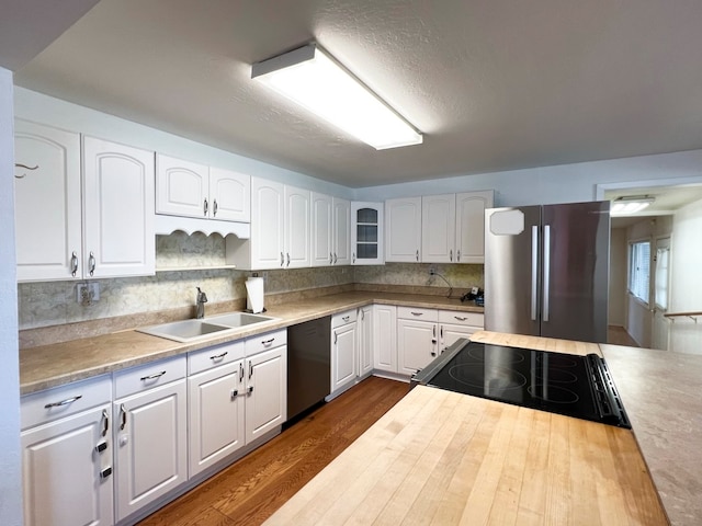 kitchen with black appliances, dark hardwood / wood-style flooring, white cabinets, and sink