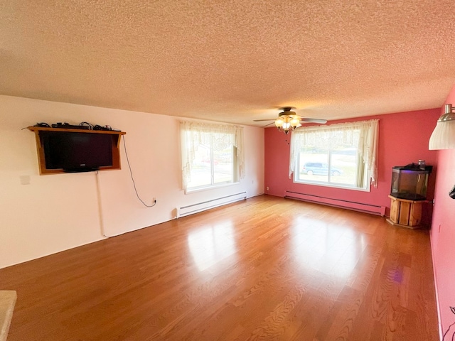 unfurnished living room featuring a textured ceiling, a baseboard radiator, hardwood / wood-style flooring, and ceiling fan