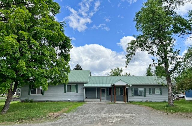 ranch-style house with covered porch and a front yard